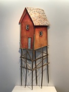 The most feasible of Hite's sculptures: a red barn, but on three layers of exceptionally long stilts. No stairs go up to the gray door.